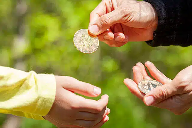adult giving gifting child bitcoin crypto