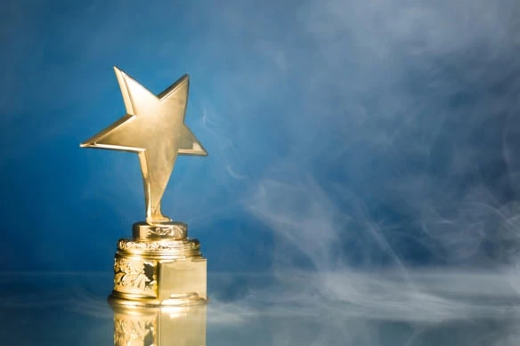 a gold trophy with a star against a blue background.