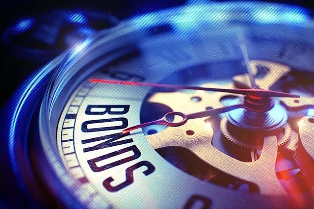 8 Best-in-Class Bond Funds to Buy 12 concept art of a watch dial pointing to the word "bonds."