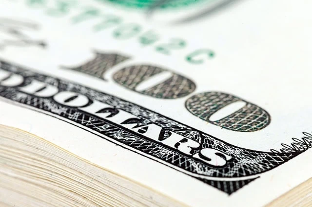 a stack of hundred-dollar bills.