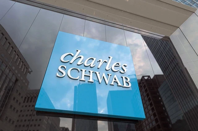 Best Schwab Funds to Hold in an HSA 4 a charles schwab sign against a glass building.