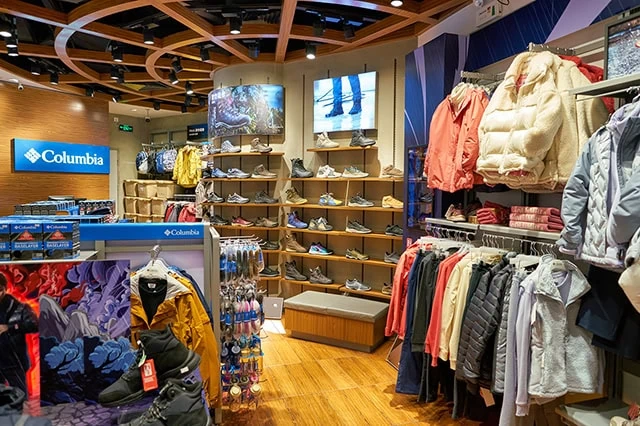 Will Tariffs Raise Consumer Prices? 7 CEOs Weigh In 9 the inside of a columbia sportswear store with many jackets and shoes on shelves and racks.