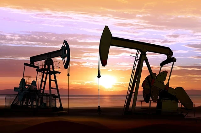 The Best Dividend Stocks: 10 Pro-Grade Income Picks for 2025 15 the silhouettes of oil rings against a sunset.