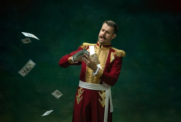 a man dressed up as a king making it rain with dollar bills.