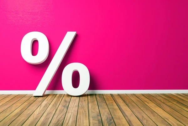a giant percent sign against a pink background.