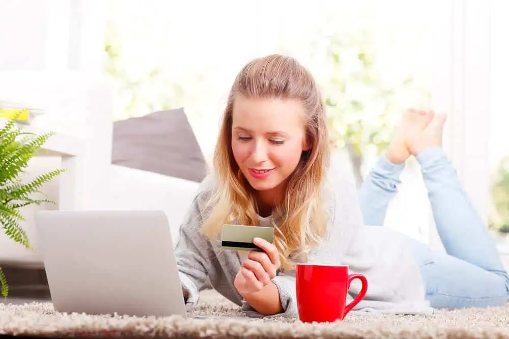 greenlight vs famzoo girl at laptop with debit card