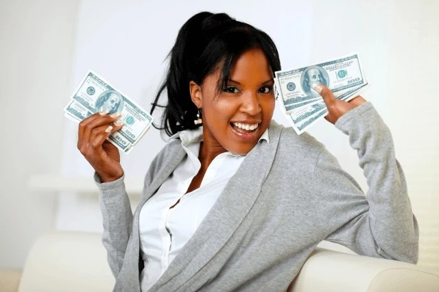 Career Compensation Is More Than Salary: 10 Other Financial Perks to Consider 8 happy woman holding cash money
