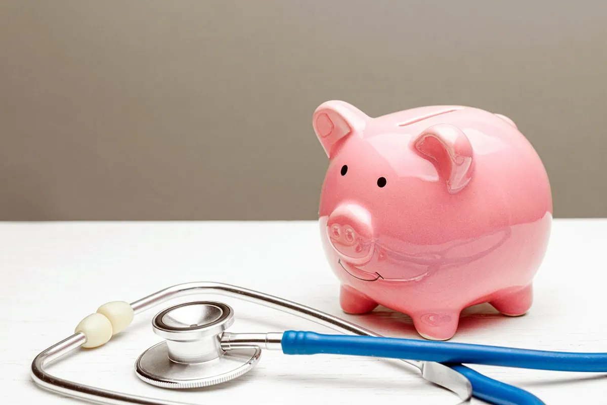 11 Best Investment Accounts 17 a piggy bank next to a stethoscope.