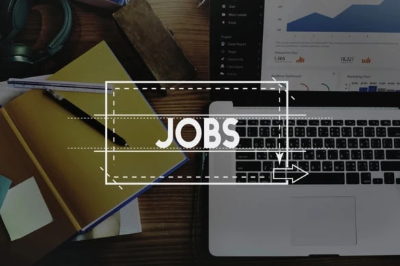 the word jobs is superimposed over a laptop and desk.