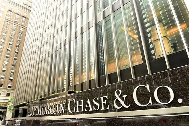 a large jpmorgan chase sign sits outside a city building.