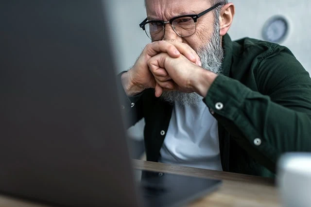 Do These 7 Bear Market Tips Hold Up to Scrutiny? 10 a man looks stressed as he views his laptop.