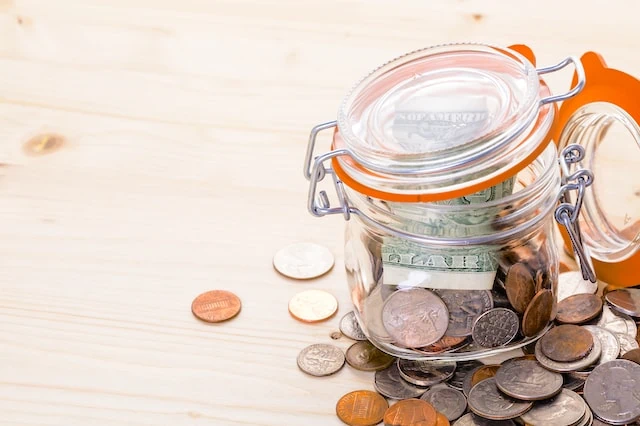 Should You Use a Financial Robo-Advisor? 6 Considerations 5 mason jar coins savings dollar bill
