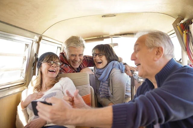 Don't Believe These 17 Social Security Myths 4 Group of senior friends in camper van using smartphone