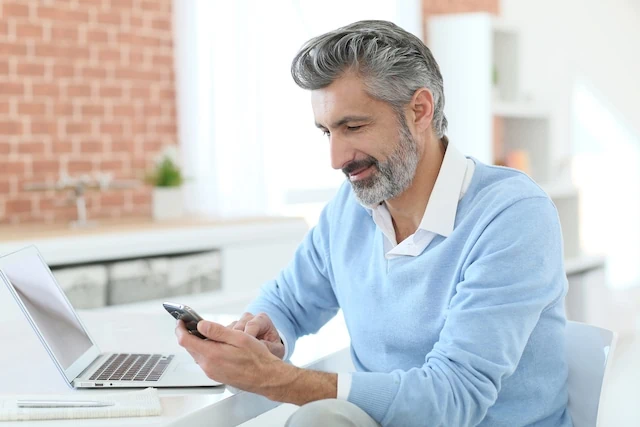 Which Type of Real Estate Investment is Right for You? 8 to Know 10 man looking at his phone and computer