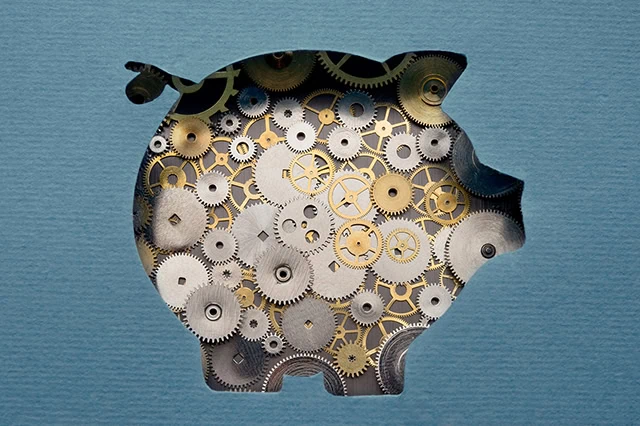 a cutout of a piggy bank with gears inside of it.