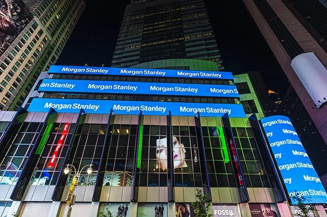 morgan stanley is displayed on a giant ticker board outside of the nasdaq building.