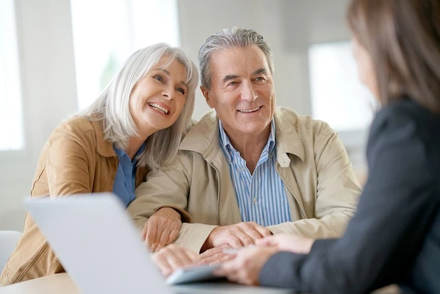 How Much Does Financial Advice Cost? 4 Senior couple meeting financial adviser for investment