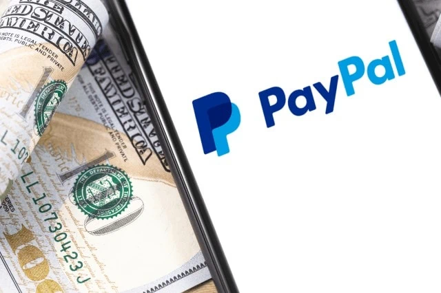 Best Debit Cards for Rewards + Cash Back 15 paypal on phone next to cash