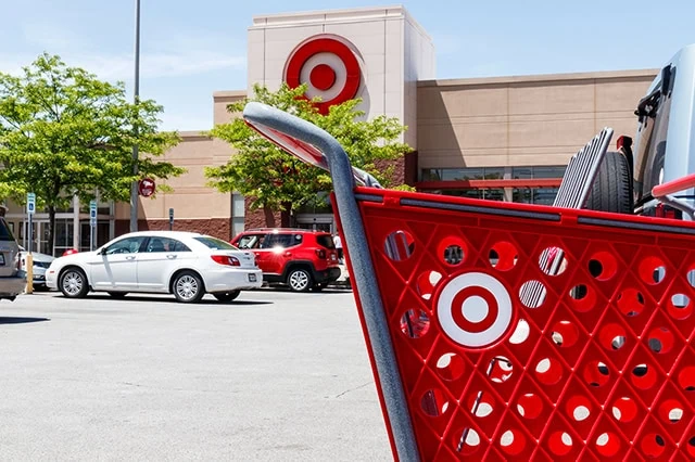 Will Tariffs Raise Consumer Prices? 7 CEOs Weigh In 7 a red target shopping cart in the foreground with a target store in the background.