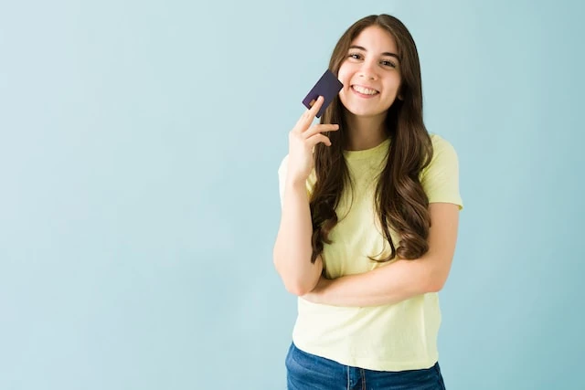 Secured Credit Card vs Unsecured: What's the Difference? 2 teen girl smiling with card in hand