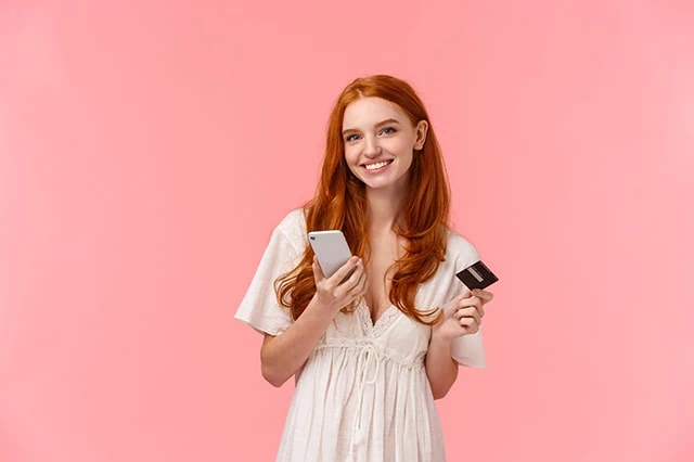 Are Credit Cards Safer than Debit Cards? Credit v. Debit Security 12 teen smartphone credit debit card pink background