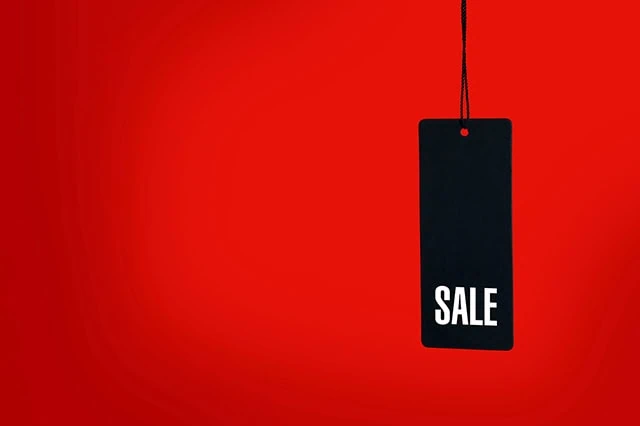 a black sale tag against a red background.