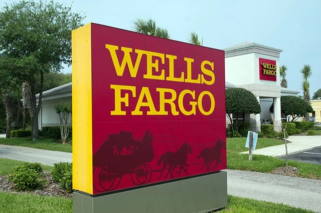 a giant wells fargo sign outside of a branch.