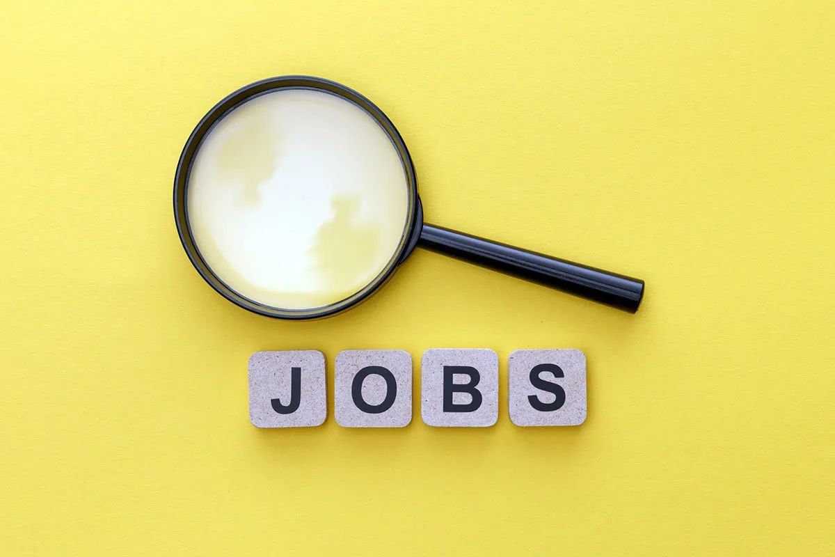 May Jobs Report: Payrolls Clear Low Expectations Yet Again 2 the word jobs is written out in block letters. above the word is a magnifying glass.