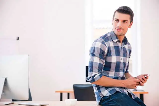 Can Bad Credit Impact Your Job Search? What to Know 2 young man on phone looking over