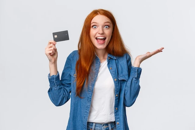 How to Get a Credit Card for the First Time: Starter Credit Cards 3 young woman credit debit card smiling white background
